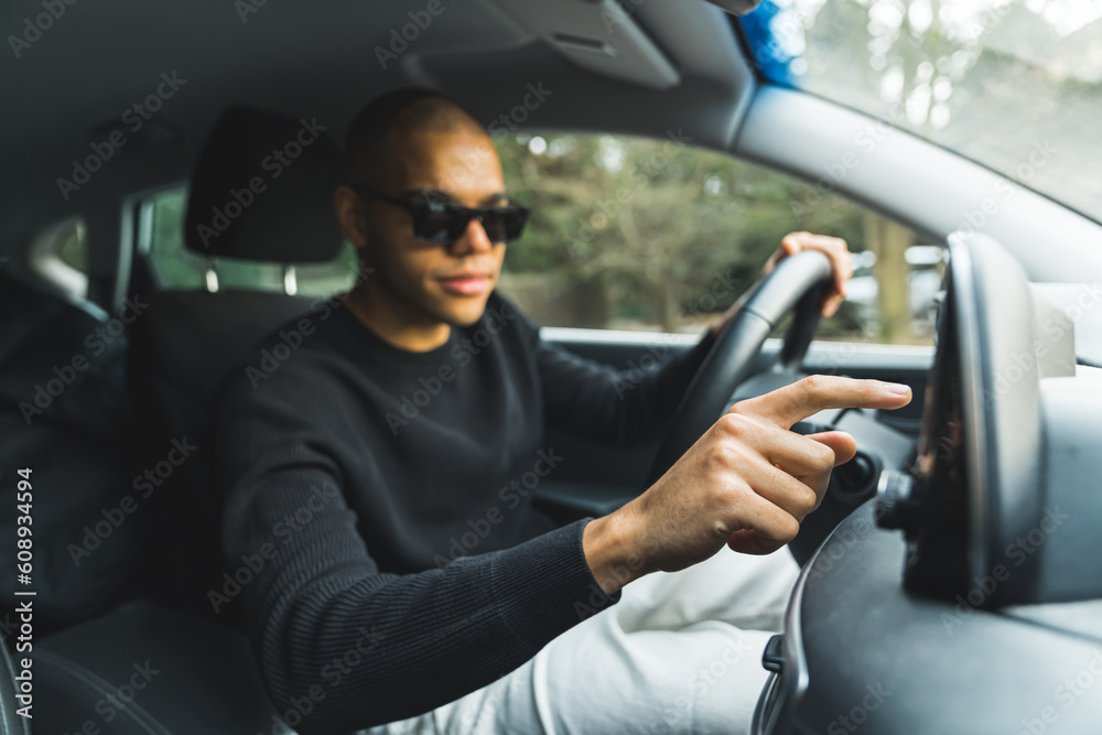 Handsome young black guy using a GPS navigation system touch screen in ...