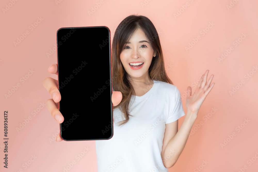 beautiful Asian young woman showing big smart phone with blank screen , white screen empty copy space for advertising banner isolated on pink background , Mock Up Image beautiful Asian young woman showing big smart phone with blank screen , white screen empty copy space for advertising banner isolated on pink background , Mock Up Image