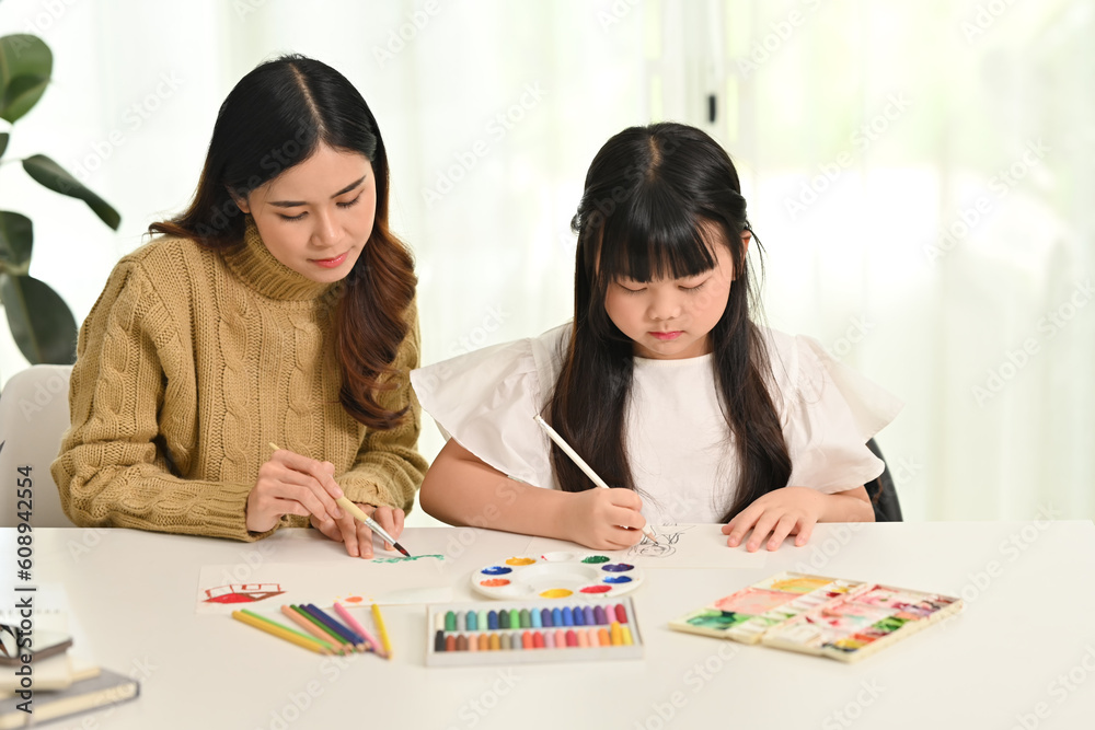 Little asian girl drawing with her mother in living room. Family home leisure concept Little asian girl drawing with her mother in living room. Family home leisure concept