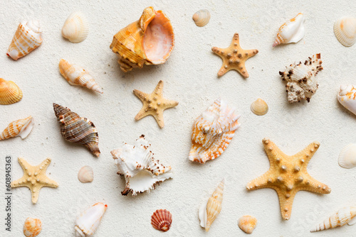 Summer time concept Flat lay composition with beautiful starfish and sea shells on colored table, top view