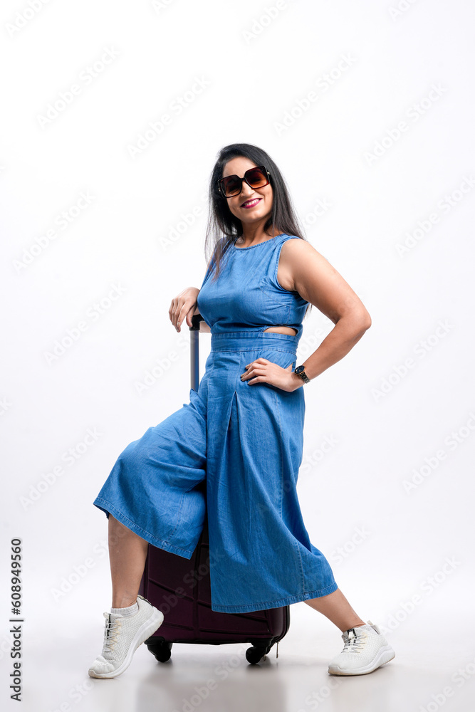Indian woman traveler carrying suitcase on white background. Indian woman traveler carrying suitcase on white background.