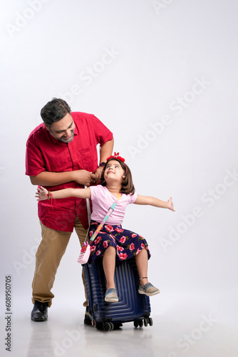Travel concept : indian father with her daughter giving flying expression on white background.