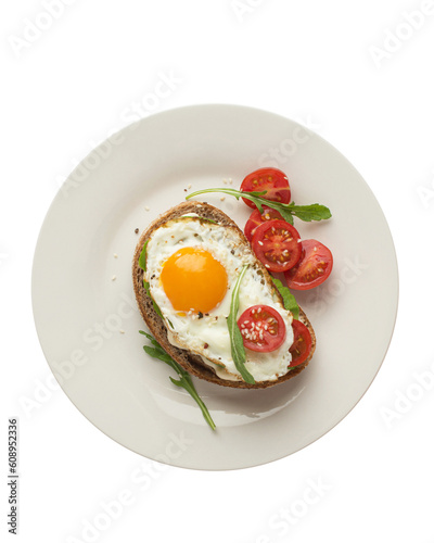 Toasts with egg, avocado and other vegetables on a gray background in a plate. healthy breakfast