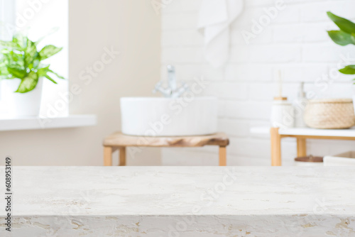 Handmade table top for product display in blur bathroom interior