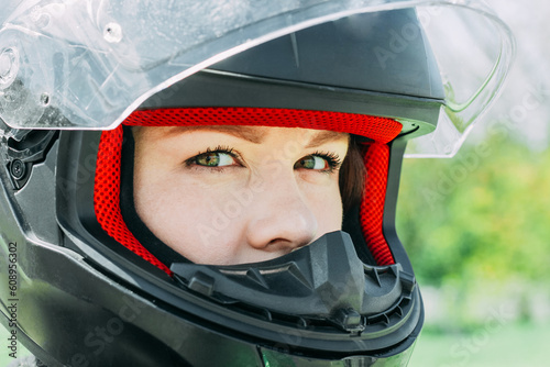 A girl in a motorcycle protective helmet close-up © ir1ska