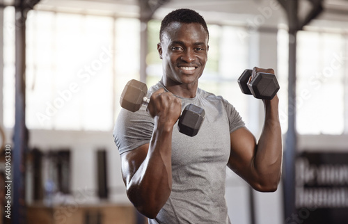 Fototapeta Naklejka Na Ścianę i Meble -  Exercise, dumbbells and portrait of a black man at gym for fitness, training workout and strong muscle. African athlete or bodybuilder person with weights for bicep power and performance at a club
