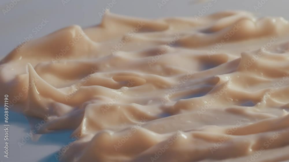 Macro shooting of white cosmetic cream texture. Rotates with a change of light. Organic cosmetics, medicine. Smooth, wave, moisturize. Close up
