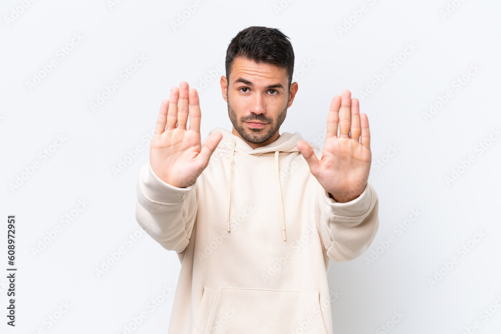 Young caucasian man isolated on white background making stop gesture and disappointed Young caucasian man isolated on white background making stop gesture and disappointed