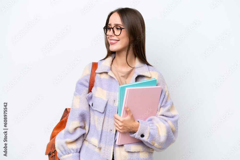 Young beautiful student woman isolated on white background looking side