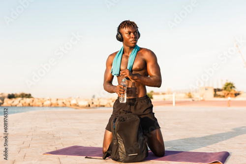 Fitness training outdoors. Handsome African man preparing for the training..