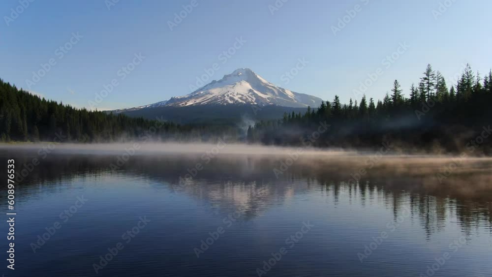 Trillium Lake drone aerial cinematic Mount Hood Oregon reflection mist fog lifting calm water canoe fishing snow ski trails early morning sunrise beautiful peaceful slowly forward movement Trillium Lake drone aerial cinematic Mount Hood Oregon reflection mist fog lifting calm water canoe fishing snow ski trails early morning sunrise beautiful peaceful slowly forward movement