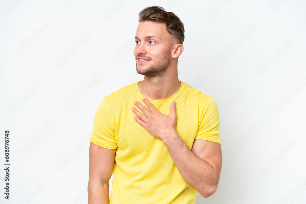 Young blonde caucasian man isolated on white background looking up while smiling Young blonde caucasian man isolated on white background looking up while smiling