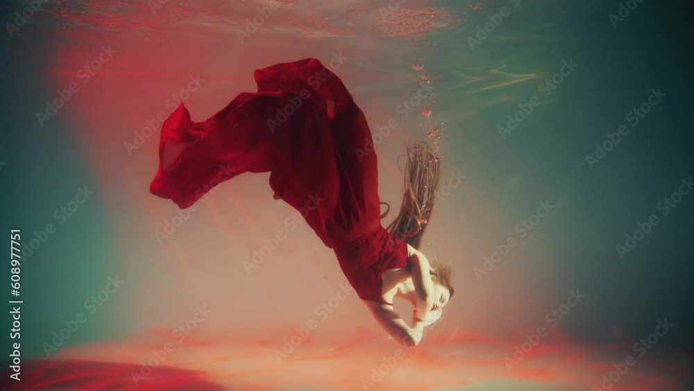 Stockvideon Fantasy mystery woman swims underwater falls asleep sinks