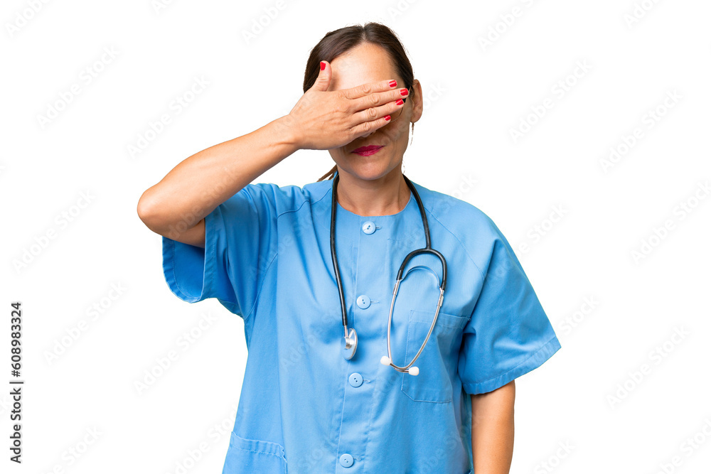Middle-aged nurse woman over isolated background covering eyes by hands. Do not want to see something