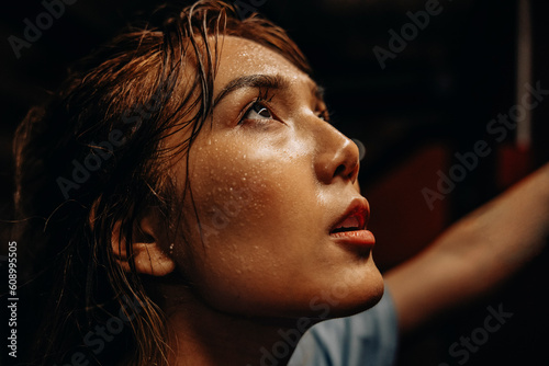 Face of female athlete with sweat while working out at gym photo
