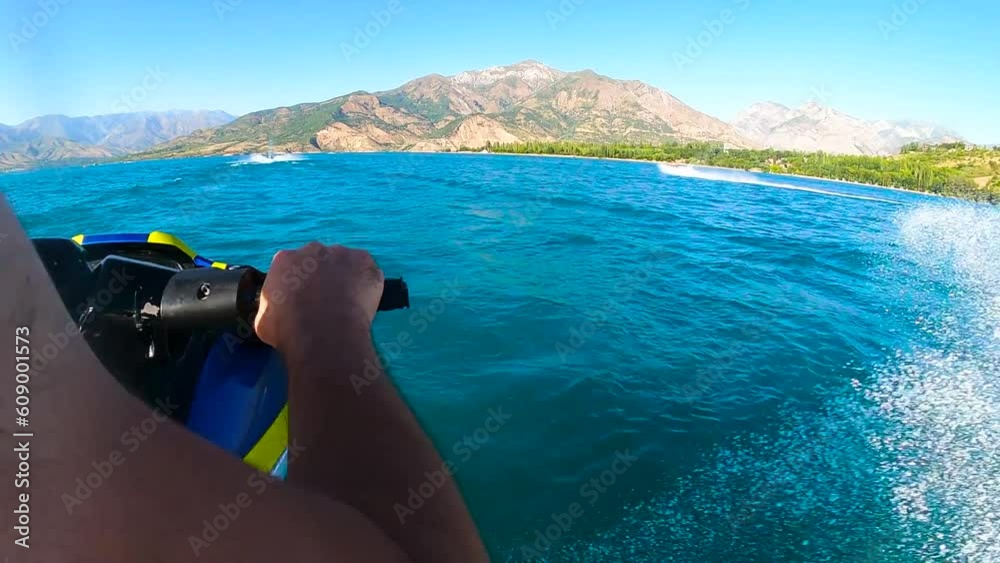 back POV (point of view) of male hands riding jet ski on sea. man riding water jet in speed. splash view from gopro. High quality Full HD footage
