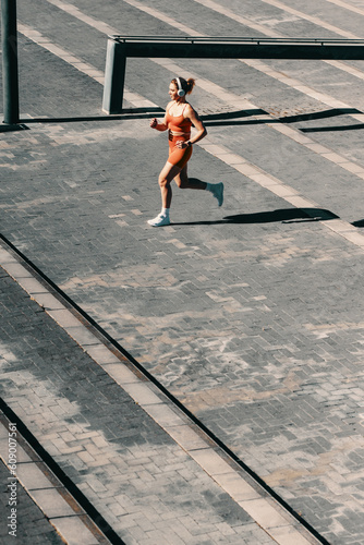 Wellbeing and exercise: Athletic woman running up stairs for cardio training