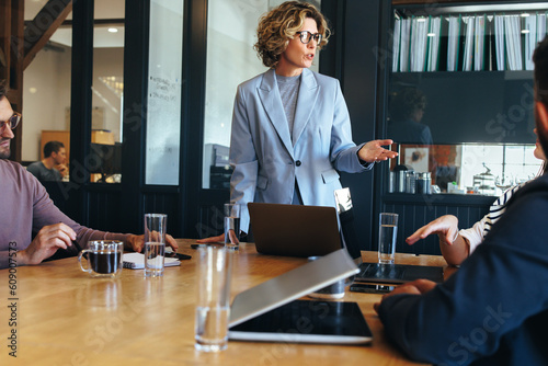 Business woman presenting an idea to her team in a meeting