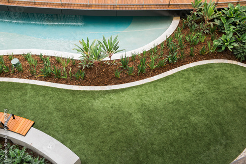 Beautiful landscaped poolside lawn area
