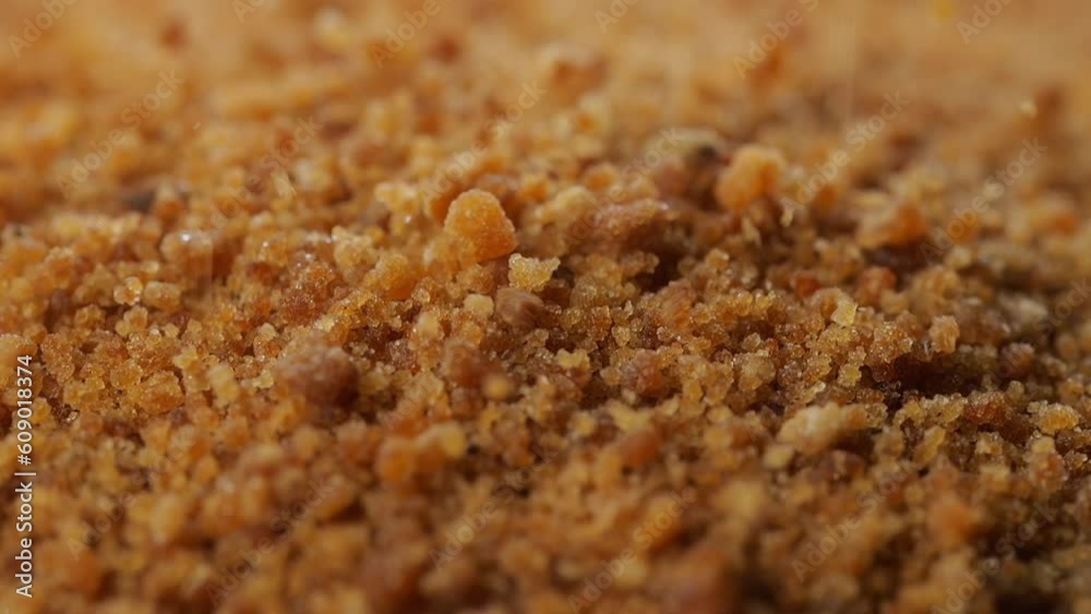 Close up organic coconut sugar falling down on a covered with coconut sugar surface. Slow motion. Close up organic coconut sugar falling down on a covered with coconut sugar surface. Slow motion.