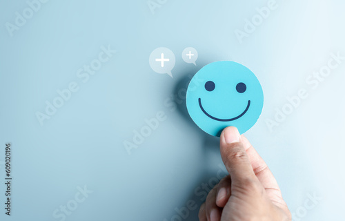 Fototapeta Naklejka Na Ścianę i Meble -  Hands holding blue happy smile face. mental health positive thinking and growth mindset concept.