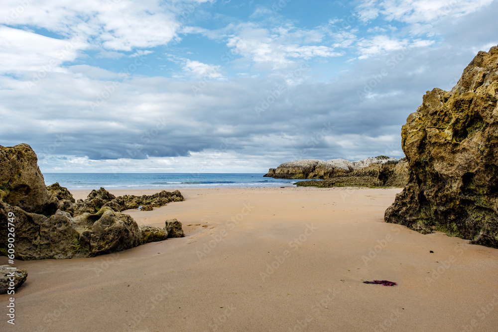 Beautiful and quiet sandy beach with rocky outcrops in the Cantabrian Coast