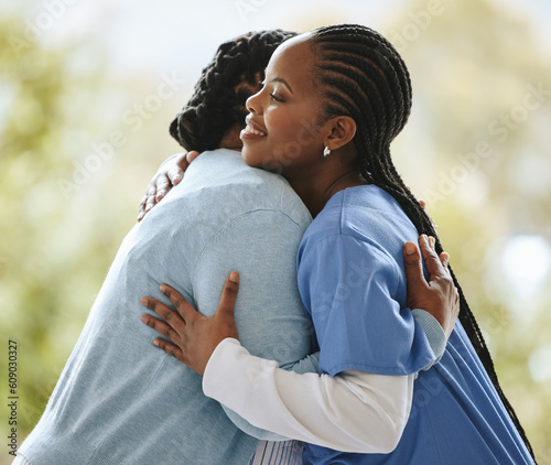 Woman patient, nurse and hug outdoor for support, healthcare and happiness at nursing home. Happy black person, caregiver and together for trust, homecare and help service for health and wellness photo