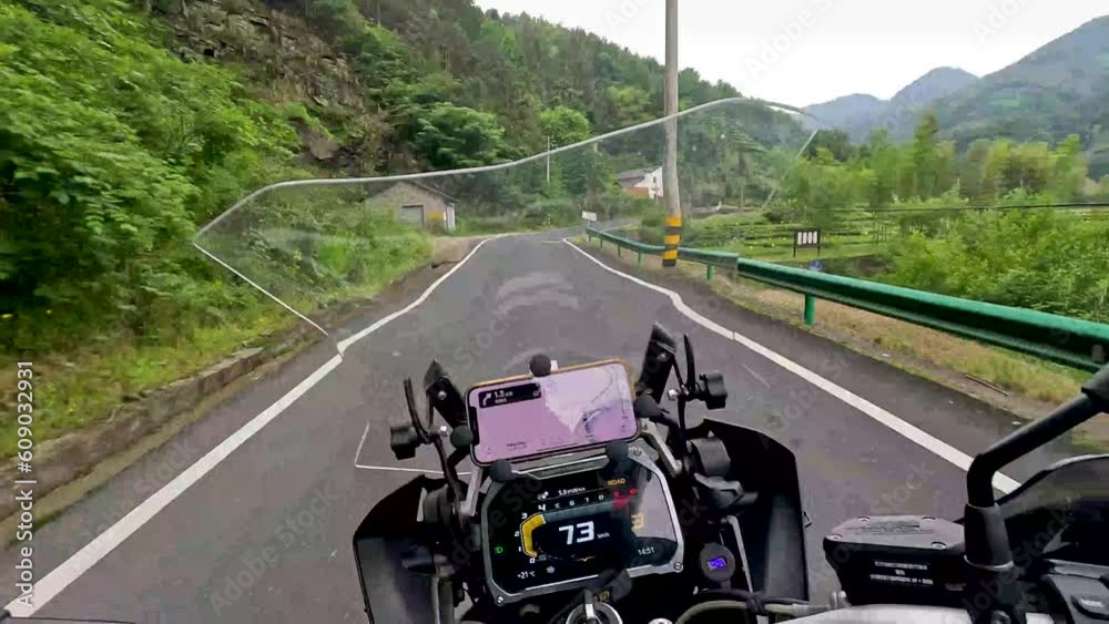 Motorcycle rider driving a motorcycle through the mountains and forests