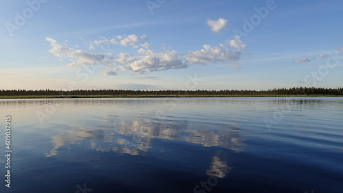 Clouds reflected on the surface of Lokka reservoir in Finnish Lapland photo