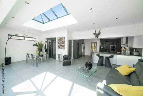 Картината върху платно Interior of modern, bright, white and grey designer open plan kitchen diner and lounge, with skylight roof lantern
