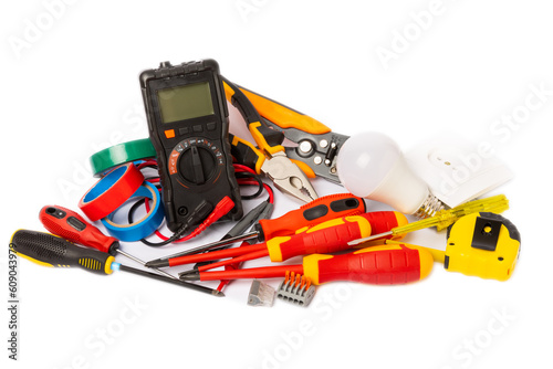 Electrician equipment isolated on white background, with copy space.Electrician tool set.Multimeter, tester,screwdrivers,cutters,duct tape,lamps,tape measure and wires.Flet lay.