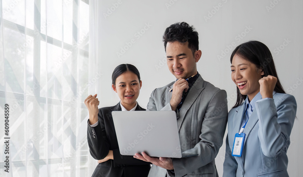 Solving problems as one team. Asian young team of male and female working together while sitting at their working place in office, enjoy, looking at the camera. Solving problems as one team. Asian young team of male and female working together while sitting at their working place in office, enjoy, looking at the camera.