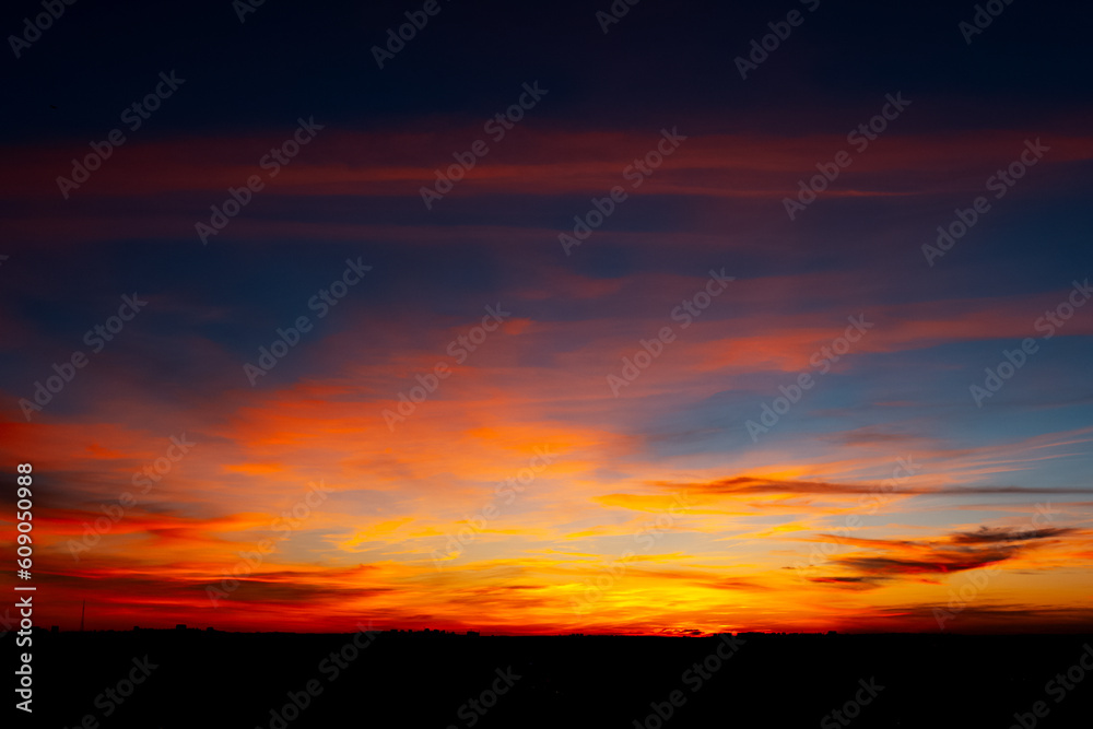 Beautiful dark landscape of vivid sunset and clouds.