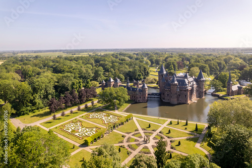 Bright view from above aerial showing historic picturesque castle Ter Haar in Utrecht with typical towers and fairy tale cants facade exterior surrounded by landscaping gardens in the foreground