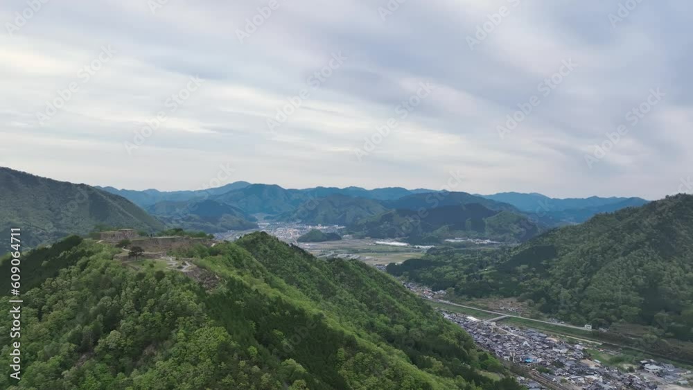 Ancient castle ruins on green mountain in Japanese landscape Ancient castle ruins on green mountain in Japanese landscape