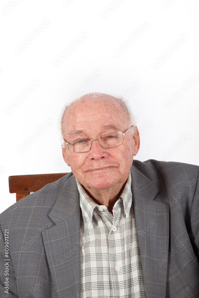 elderly smart confident man sitting in his armchair elderly smart confident man sitting in his armchair