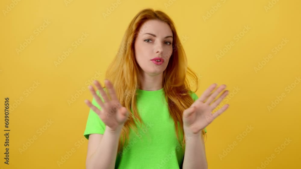 No gesture, stop and woman showing disagreement end expression. Serious ginger lady, no way ignore finish stop emotion. Body language concept, studio isolated on yellow background No gesture, stop and woman showing disagreement end expression. Serious ginger lady, no way ignore finish stop emotion. Body language concept, studio isolated on yellow background