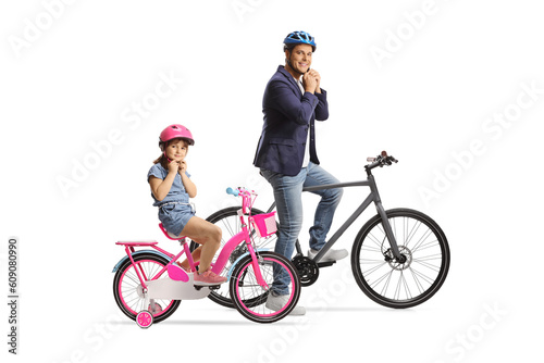 Father and daughter with bicycles putting helmets on