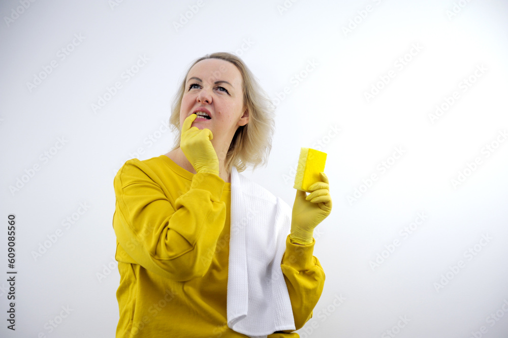 Image of a happy excited young housewife woman in gloves holding mobile phone and credit card isolated over pink wall background. High quality photo Image of a happy excited young housewife woman in gloves holding mobile phone and credit card isolated over pink wall background. High quality photo