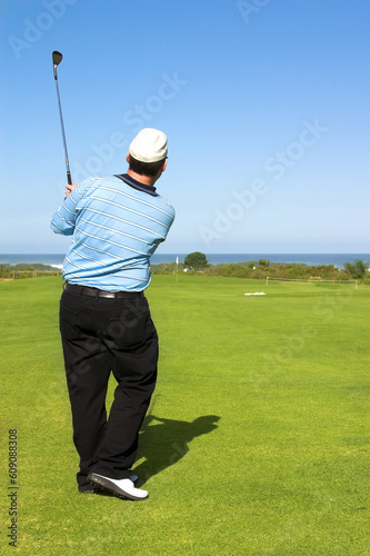 Golfer following the shot.
