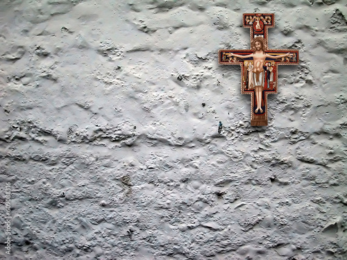 cheap plaster crucifix hanging on rustic wall