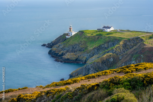 View of green heather fields, the Baily Lighthouse and the Irish Sea seen from the Howth Summit in Howth, near Dublin, Ireland