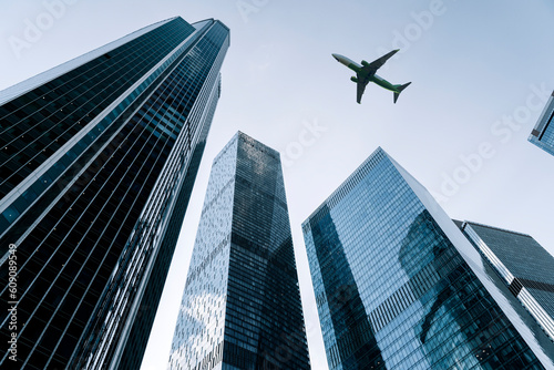 Photography Airplane flying on business skyscrapers of financial center