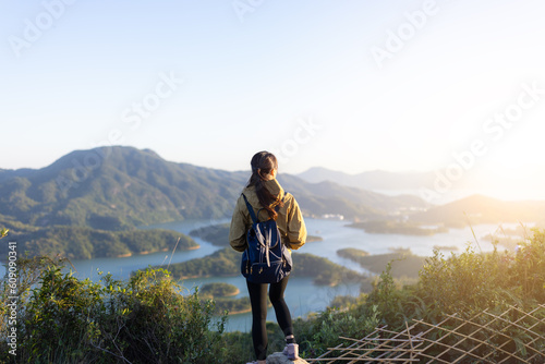 Photography Hiking woman stand on the mountain and enjoy the sunset view