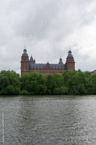 Castle in Aschaffenburg with a river and a cloudy sky