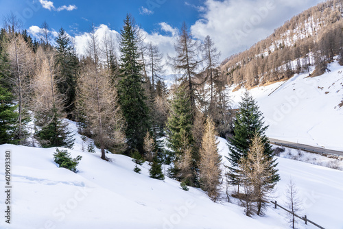 Winter scene at Resia Lake with sunken gray steeple. Resia Lake is an artificial lake located in the western portion of South Tyrol, Italy, near the Resia Pass.