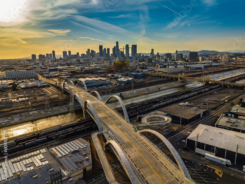 New 6th Street bridge in Los Angeles at sunset with the Los Angles skyline. Beautiful view of LA river with 6th street bridge against sunset. Aerial view of downtown Los Angeles city skyline  photo