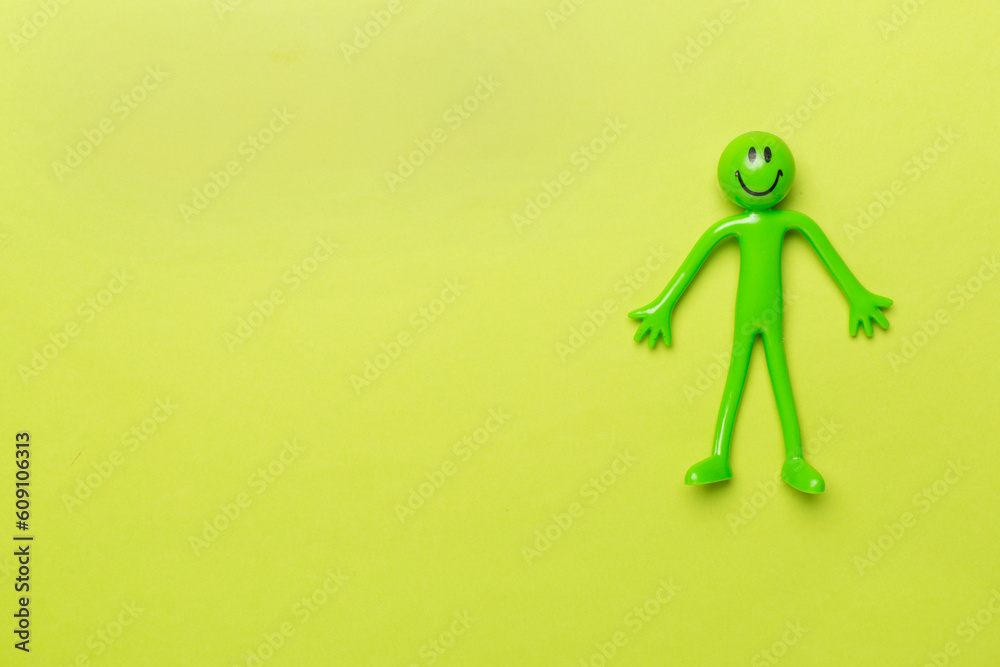 Human figure toy on color background, top view Human figure toy on color background, top view