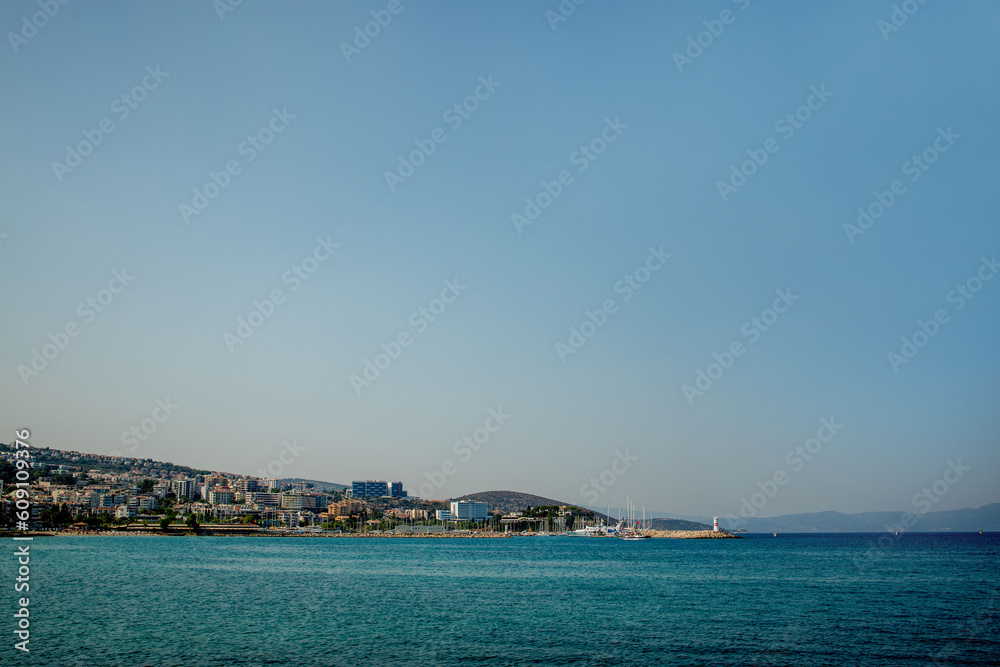 A view of a populated Turkish city on the seashore. Mountain horizon of the seashore