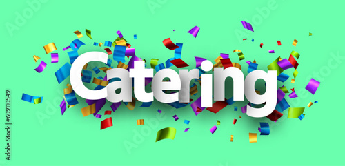 Catering sign over cut out ribbon confetti on green background.
